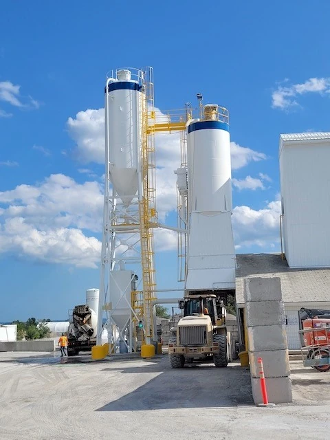 Ready Mix Concrete and Admixtures - ready-mix plant silos with a loader in the yard