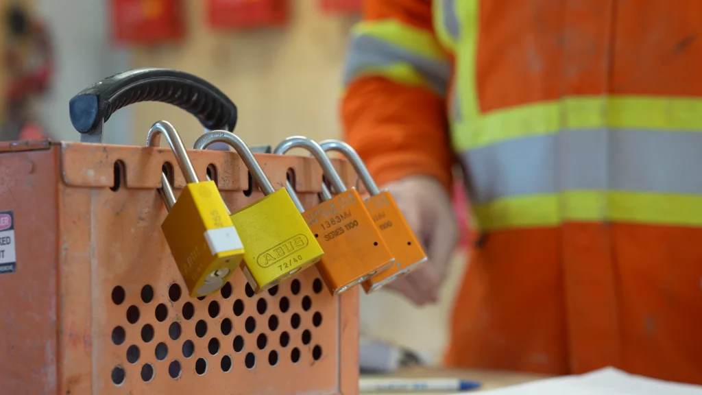 a close-up of locks on a lock out box at a plant.