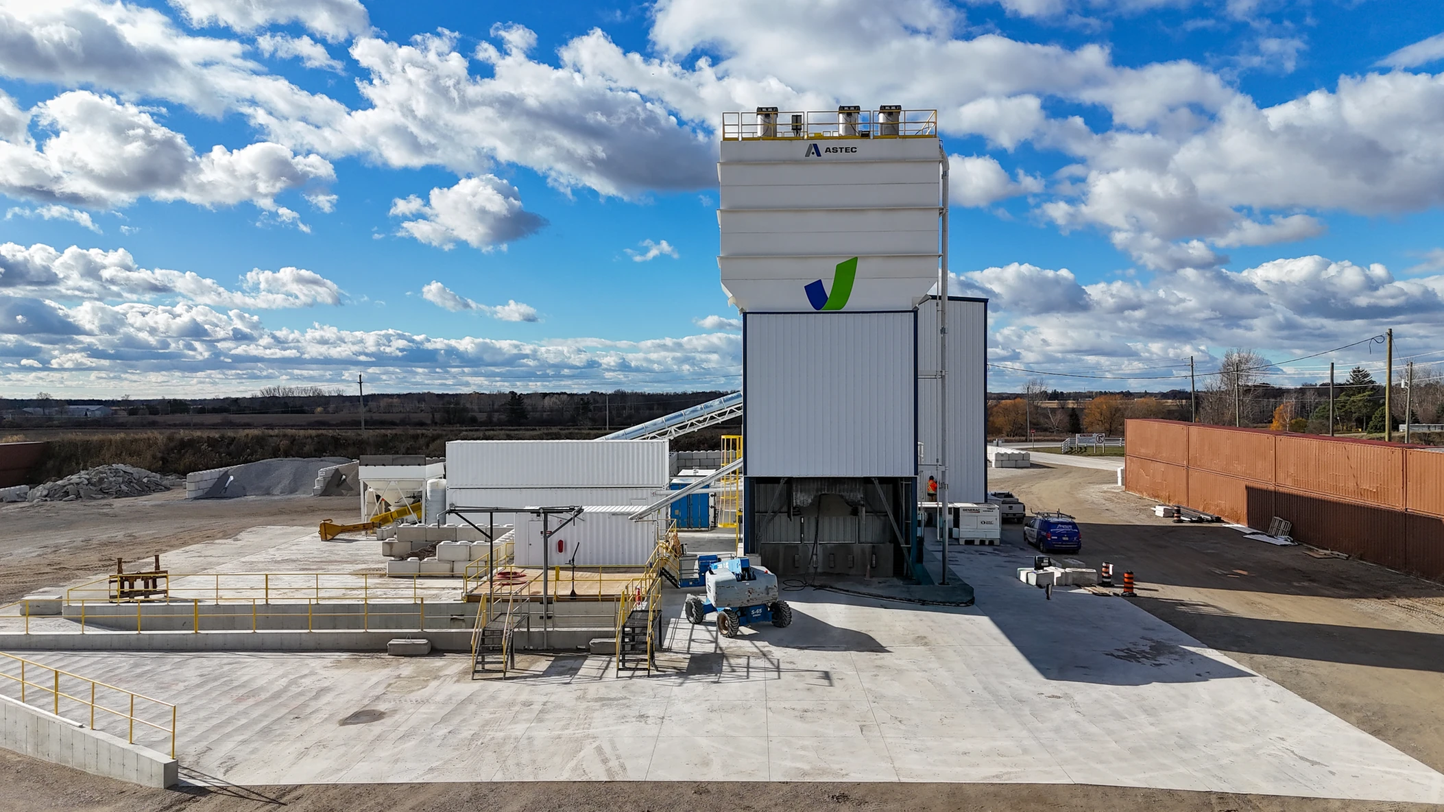 Ready-mix concrete plant with a VCNA logo under a blue sky