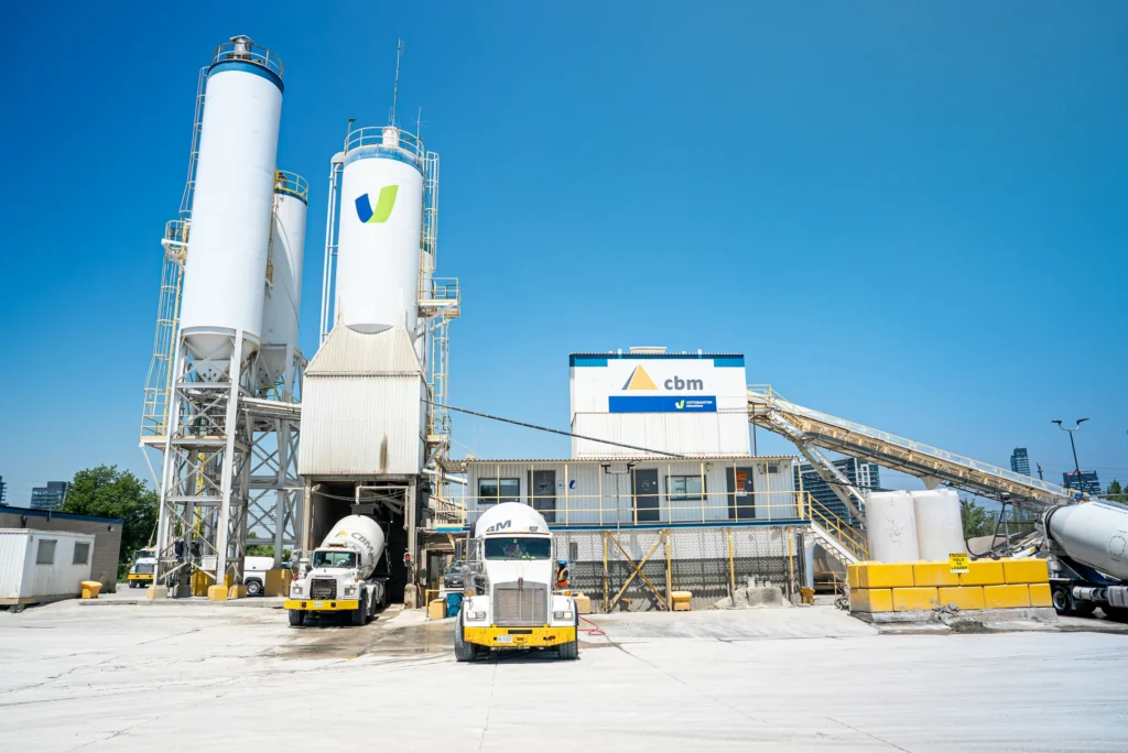 Contact Canada Building Materials - CBM ready-mix plant with silos and mixer trucks in the yard